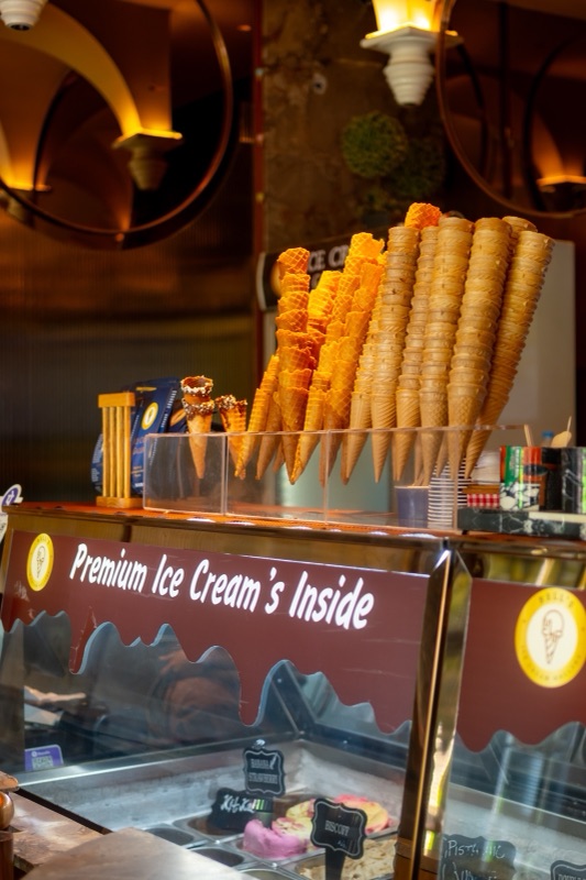 The Bell’s counter at night: a tall cone display under warm wall lamps
